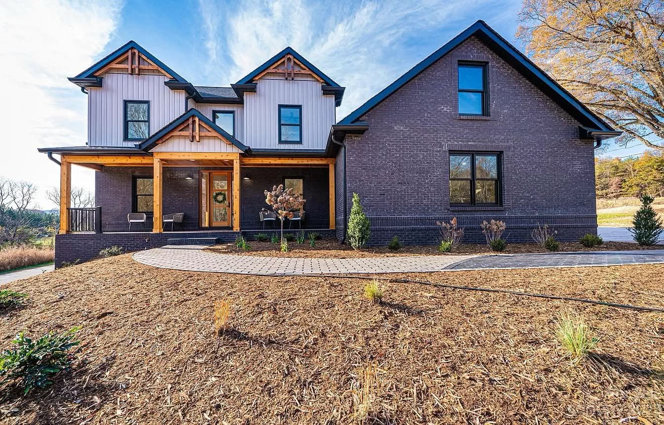 Completed Southern Valley Properties home with brick, timber porch, and landscaped front entry